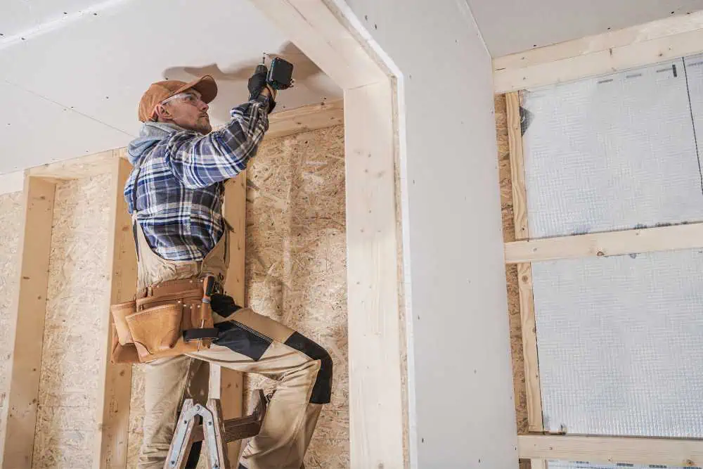 Contractor diligently working in an unfinished home construction site in Ventura County, provided by Nativi Construction.