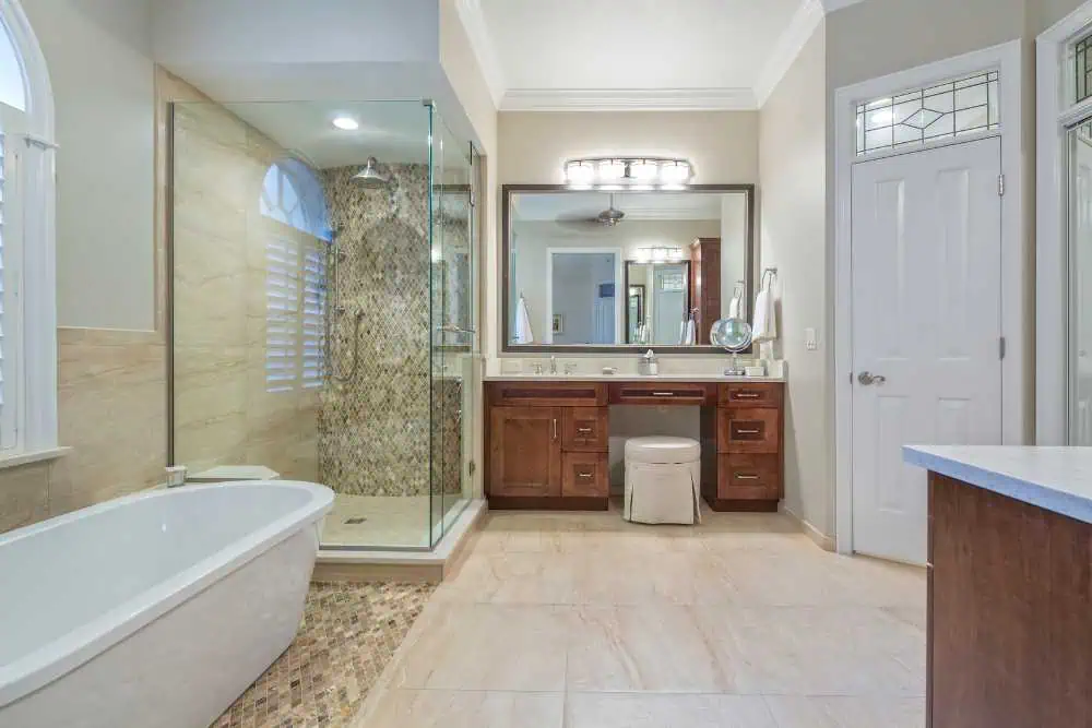 Contemporary bathroom featuring wooden cabinets and a stylish glass enclosure, crafted by Nativi Construction in Ventura County.