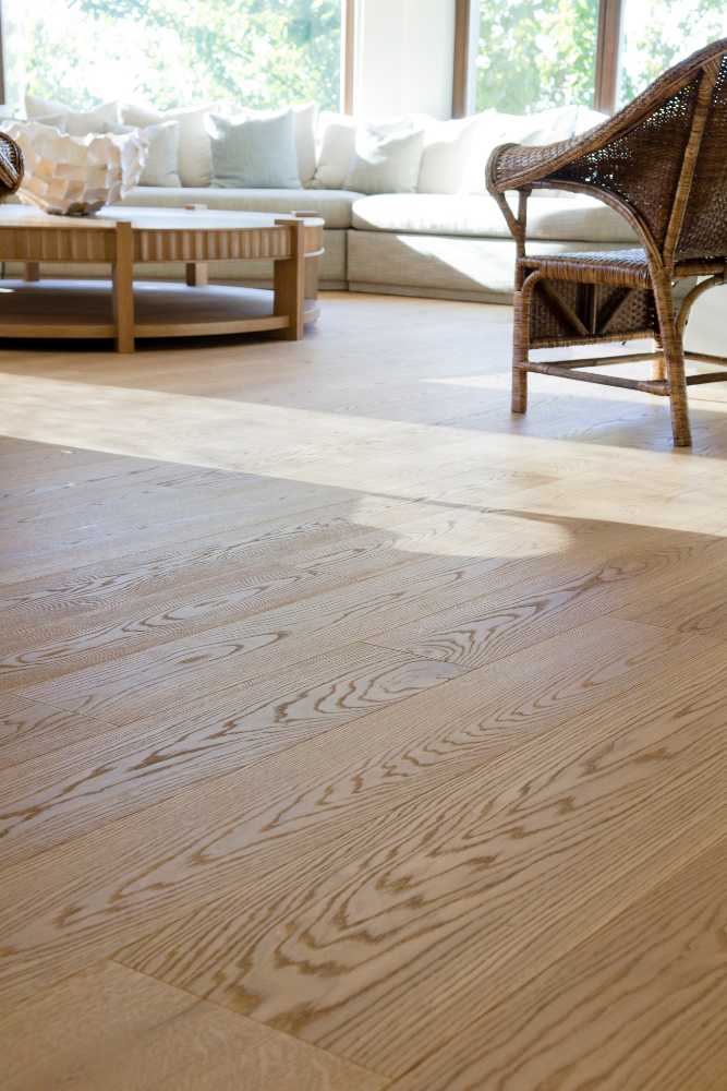Contemporary living room showcasing rich brown wood flooring installed by Nativi Construction in Ventura County.